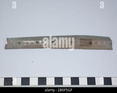 Fragment of a one-sided three-layer comb, handle leaf. Type: Long comb. Decoration: dot circles, vertical lines and cross Stock Photo