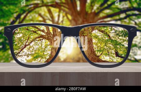 Vision concept. Eye glasses on wooden table. 3d rendering Stock Photo