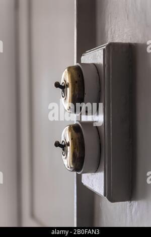 Original brass light switches in Georgian home. Stock Photo