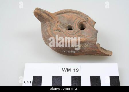 Terracotta oil lamp, decorated with a rooster, with ear, filling hole and large air hole. The spout is largely missing., Oil lamp, earthenware, terracotta, 9.5 x 5.6 x 4.1 cm, roman, Netherlands, Gelderland, Nijmegen, Nijmegen Stock Photo