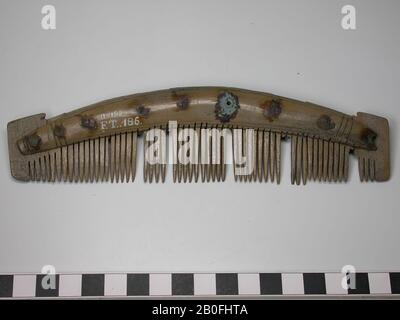 Single-sided three-layer comb. Type: wing comb. Decoration: handle sheets: lines running parallel to the edges and vertical lines. Both handles: identical decorated. Shape: slightly curved handle blades, no straight base. Thick handle blades. Small wings. Teeth plates: 9. End plates: 2. Original number of tooth plates: 11. Teeth: 57 whole teeth (barely worn). Broken teeth: 7. Original number of teeth: 64. Rivets: 9. The comb is almost complete. One of the handle blades: part of the end broken off. One end plate: saw tracks that run across the end plate. Saw marks handle blades: first the teeth Stock Photo