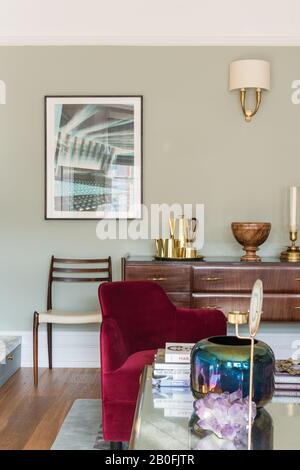 Blend of vintage and contemporary pieces, Yoko sideboard and bespoke armchair in red velvet