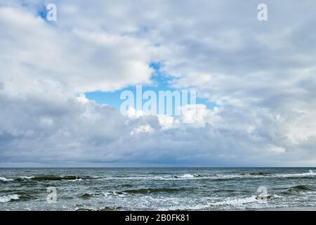Dramatic cloudy sky over sea horizon after rain. Stock Photo