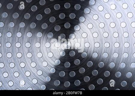 Flat metal surface with round aluminum inserts, rough machining, texture. Stock Photo