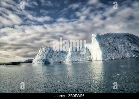 5 Isolated Iceberg below the dramatic clouds -- Jokulsarlon, Iceland Stock Photo