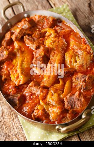 Khoresh bademjan is a deliciously balanced Persian stew that is prepared with eggplants, lamb or beef and tomatoes closeup in a pan on the table. Vert Stock Photo