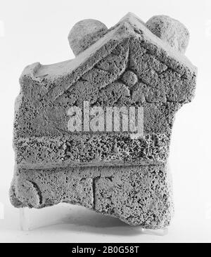 Upper left part of an altar without a niche. Limestone. The main frame is a relatively high rising pointed roof, decorated in the front with a sculpted fruit and leaf motif. On the top is a pear with a long handle on the left, an apple on the right. To the left, instead of a roll, only a ledge has been applied. On the front and side is a cornice. On the left side is a relief unrecognizable relief. The back is completely flat and undecorated., Altar, fragment, stone, limestone, 20 x 15 x 10.8 cm, roman 150-250, the Netherlands, Zeeland, Noord-Beveland, Colijnsplaat, Oosterschelde Stock Photo