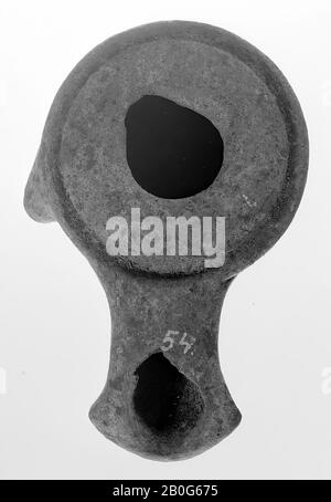 An unvarnished oil lamp of gray earthenware with a high round body on a round base. The mirror is convex and the filling hole is small. On the left is an outgrowth. The long spout is wide and angularly sealed, oil lamp, earthenware, terracotta, 4 x 8.2 x 5.5 cm, 4th and 3rd century BC. -400 Stock Photo