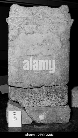 Upper part of an altar without a niche. Limestone. The top and front are badly damaged. The mensa is flat. On the rear part of it, a remainder of a small increase (probably a fruit) is visible. The scroll on the left side of the mensa is decorated with a triangular figure. The main frame is separated from the shaft at the sides and at the rear by a protruding frame. Probably such a list was also on the front. On both sides there is a cornucia, under the middle of drooping leaves. On top of the left cornucopiae three fruits can be distinguished, a large flanked by two smaller ones. This part is Stock Photo