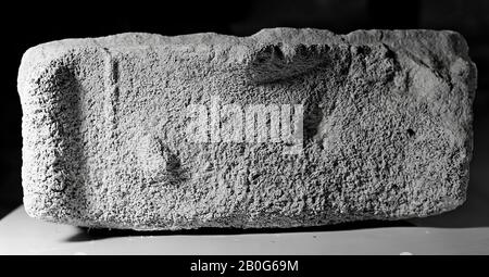 Upper part of an altar without a niche. Limestone. The altar is broken off from the 4th line of the inscription on the left until the second line on the right. The plane on which the inscription stands is undecorated. Above it is a large, profiled cornice, also on the sides. The sides have probably been undecorated. The mensa has a slowly rising pediment at the front with carved ornamentation. There are rolls to the left and to the right, on the mensa you can see a fruit on the right in the middle. The back side has been eaten so much that nothing can be said about its original state., Altar Stock Photo