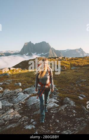 Woman adventurer hiking in mountains travel vacation healthy lifestyle active summer backpacking leisure in Norway Stock Photo