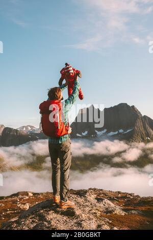 Father holding up child family travel vacations with infant baby hiking in mountains together active healthy lifestyle outdoor parents childhood gener Stock Photo