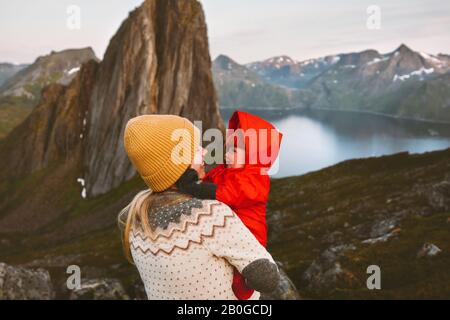 Mother and baby family traveling in mountains hiking healthy lifestyle mom and child together active vacations trip outdoor in Norway Stock Photo