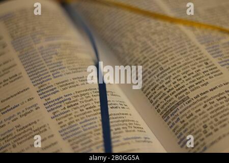 Munich, Bavaria/Germany - 01.22.2020 opened dictionary (english-german) with a blue and a yellow bookmark Stock Photo