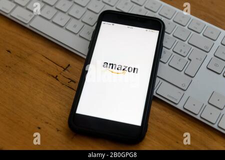Paris, France - February, 20, 2020 : Mobile phone displaying the Amazon site on a wooden background Stock Photo