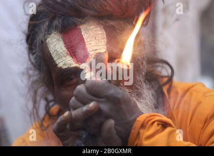 A Hindu Sadhu or Holy Man smokes marijuana at the premises of Pashupatinath Temple during the eve of the Hindu festival Maha Shivaratri in Kathmandu on February 20, 2020. Maha Shivaratri is celebrated annually in honour of Lord Shiva. (Photo by Subash Shrestha/Pacific Press) Stock Photo