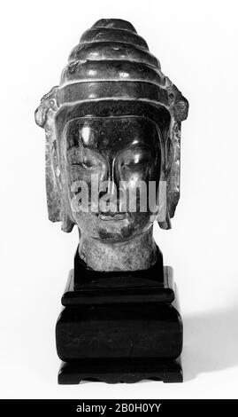 Northern Ch'i Dynasty, Chinese, Head of a Monk, c. 580, Stone (possibly limestone) with wood base, Overall: 8 1/4 x 21 1/4 in. (21 x 54 cm Stock Photo