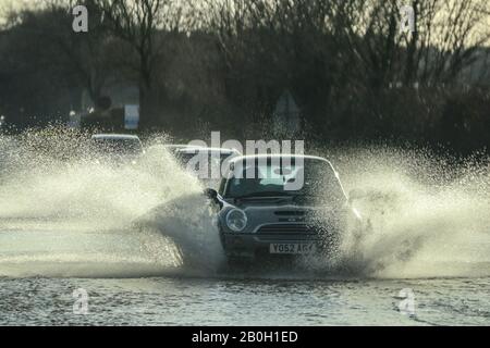 Carnforth Lancashire, United Kingdom. 20th Feb, 2020. Flooding on the A6 caused by run of from surrounding farm land caused River Keer to burst it banks and flood the A6 Credit: Photographing North/Alamy Live News Stock Photo