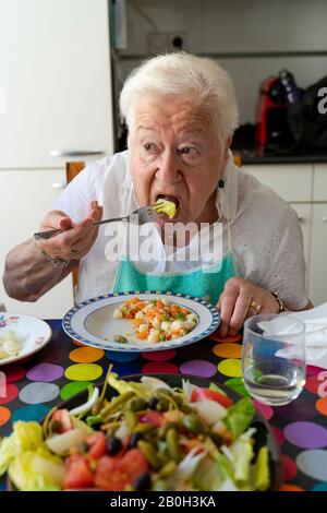 Old lady eating alone healthy food at home Stock Photo