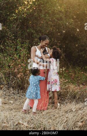 Portrait of young mother and three girls standing in field Stock Photo