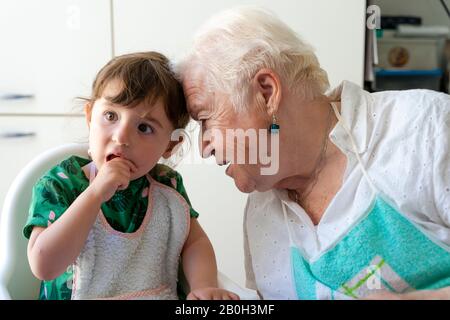 grandmother and granddaughter resting their heads with love Stock Photo