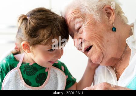 grandmother and granddaughter resting their heads with love Stock Photo