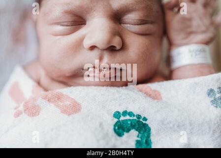 Close up detail of newborn boy face in hospital Stock Photo