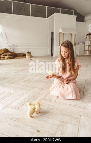 girls playing with ducks for Easter Stock Photo