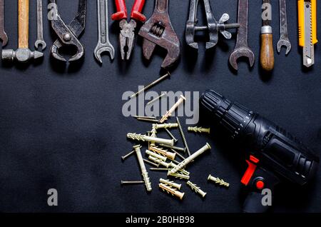 Construction worker tools on a dark background top view. Stock Photo