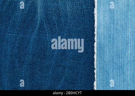 Jeans torn denim texture. Material, background. Light blue denim jeans fragment. Vintage jeans torn denim texture. Stock Photo