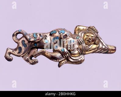 Belt Hook in the Shape of a Warrior and a Leopard, North China, 3rd–1st century B.C., North China, Gilt bronze with inlaid turquoise, H. 1 1/4 in. (3.2 cm); W. 3 in. (7.6 cm), Metalwork Stock Photo