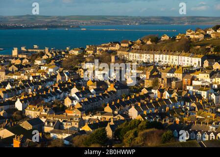 Fortuneswell, Portland, Dorset, UK.  20th February 2020.  UK Weather.  View across Fortuneswell on the Isle of Portland in Dorset during late afternoon sunshine and gusty winds. Picture Credit: Graham Hunt/Alamy Live News Stock Photo