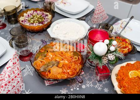 Fish fillets in breadcrumbs in oil and onions, standing in a bowl on the Christmas table in Poland. Stock Photo