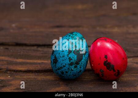 Traditionally painted quail eggs on a wooden background. Happy Easter / place for text Stock Photo