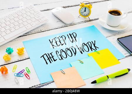 office position. card with the mobilizing slogan "Keep Up The Good Work" The concept of efficient work / place for text Stock Photo