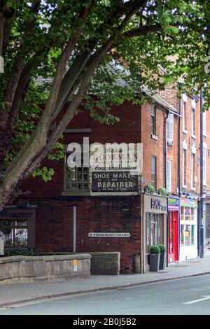 Vintage ghost sign on brick building exterior in Derby, England Stock Photo