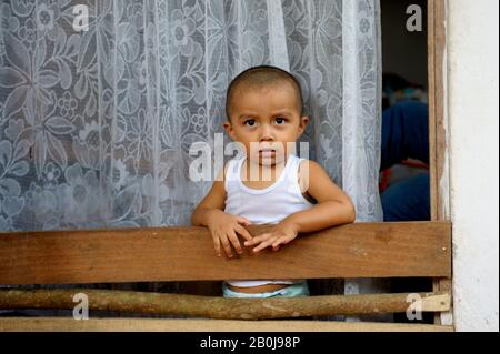 COSTA RICA, NEAR FORTUNA, MALEKU TRIBE, INDIAN VILLAGE, STREET SCENE WITH SMALL BOY Stock Photo