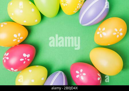 Colorful Easter eggs on white wooden table Stock Photo
