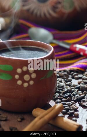 Cafe de Olla. Traditional Mexican coffee, brewed in a clay pot with cinnamon and piloncillo, a raw cane sugar product often formed into cones. Stock Photo