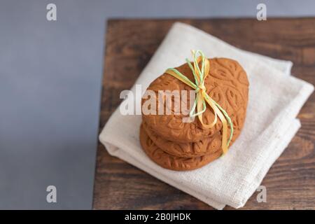 Easter egg shaped ginger cookies on the kitchen towel background Stock Photo