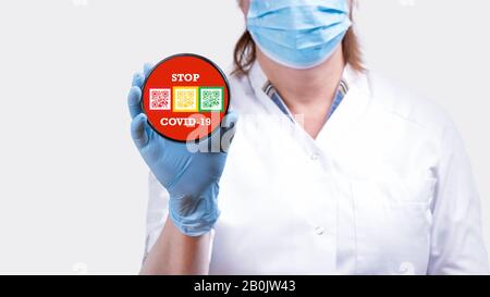 Female doctor hand holding stop sign with text do not enter coronavirus 2019-nCoV against red background conceptual image. Stock Photo