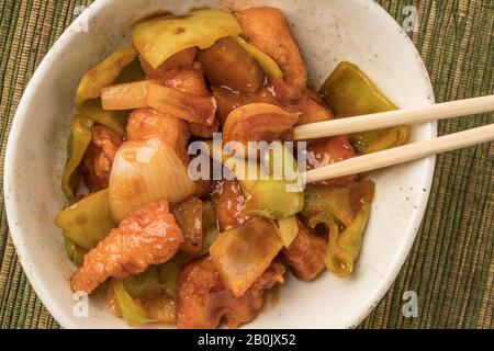 closeup bowl of sweet and sour chicken on a table Stock Photo