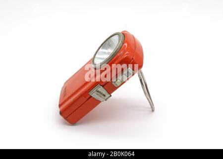 Vintage metal orange flashlight torch, isolated on a white background Stock Photo