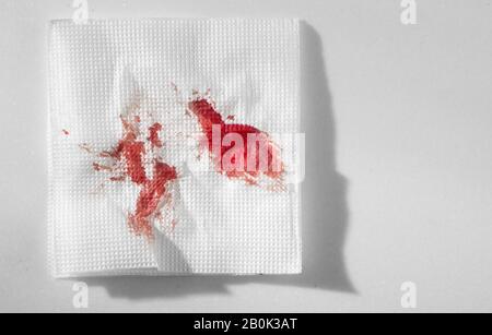 Kitchen paper napkin in the blood. Stopping blood by improvised means. Stock Photo