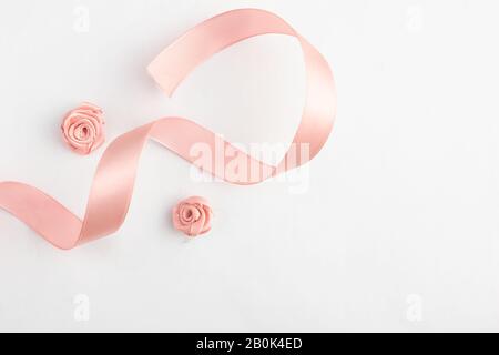 A Pink ribbon on a white background. Stock Photo