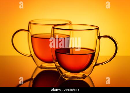 Two double wall glass cups with tea. Stock Photo