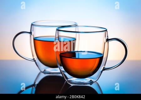 Two double wall glass cups with tea. Stock Photo