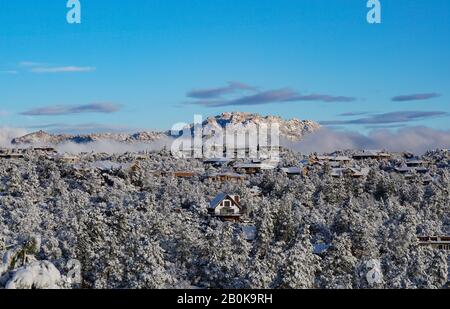 Granite Mountain and the valley below covered in snow in the morning light. Stock Photo