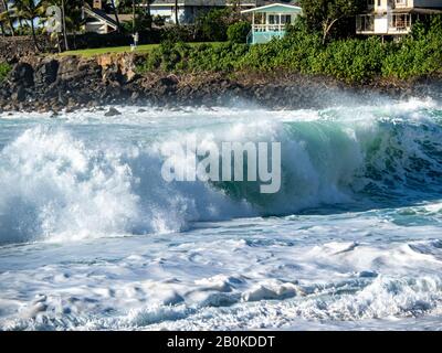 : Big waves on the north shore of Oahu with aquamarine seas, white foam and blue skies. Stock Photo