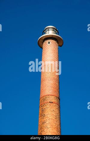 Industrial fireplace made of bricks in front of a blue sky Stock Photo